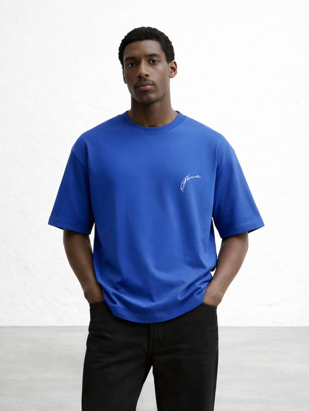 Man wearing a blue t-shirt with a logo on a white background