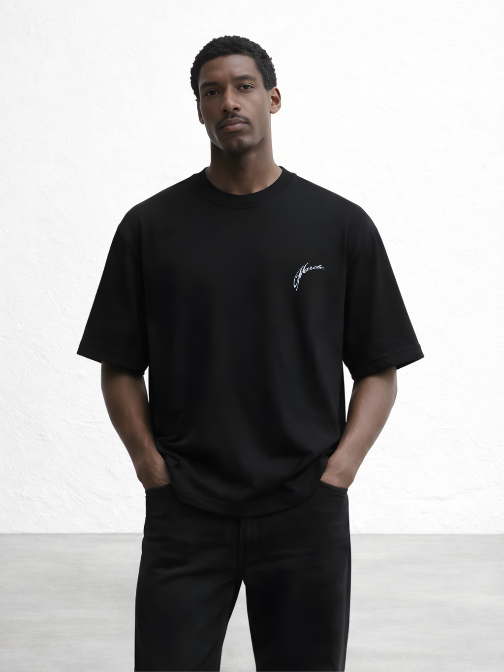 Man wearing a black t-shirt with a logo on a white background