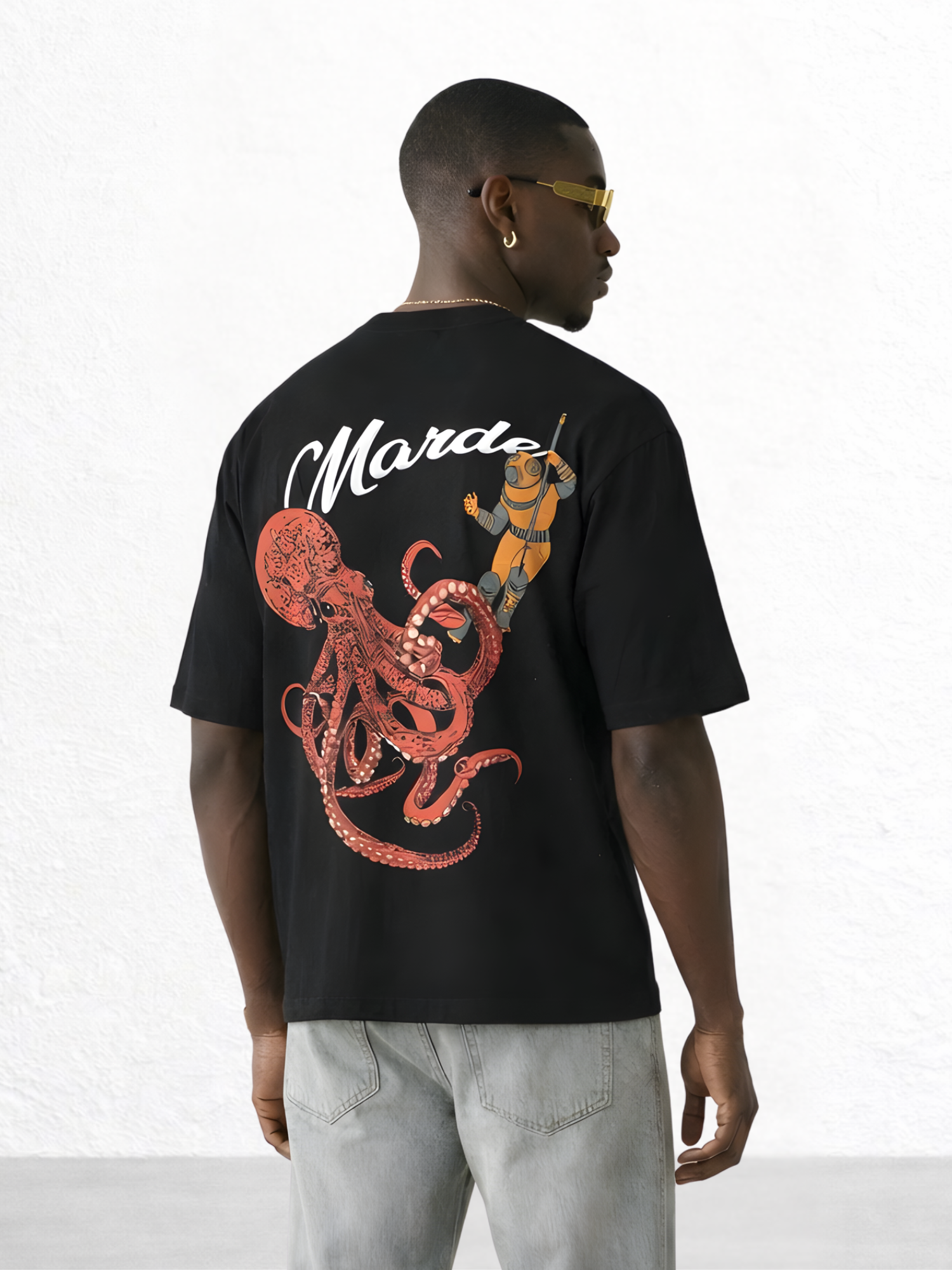 Man wearing a black t-shirt with a red octopus design and 'Marte' text on the back.