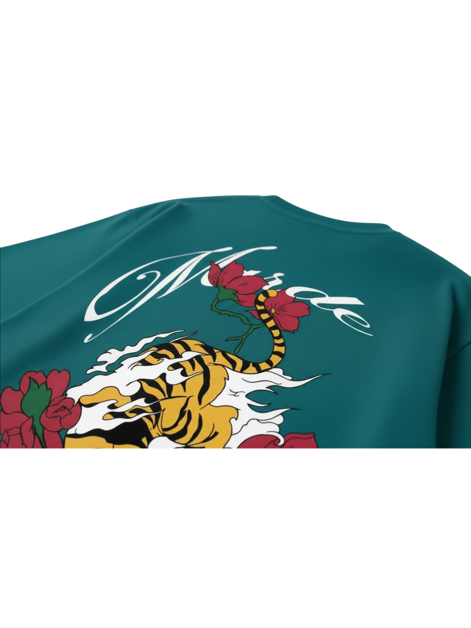 Teal t-shirt with a tiger and floral design on a white background